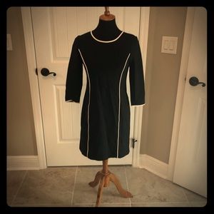 Black dress with white piping.